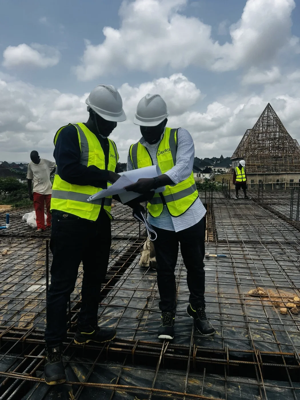 Dantata Town Developers team reviewing drawings on an active construction site
