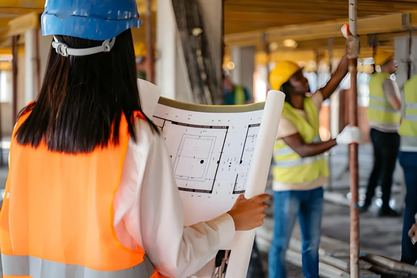 Site manager reviewing building plans on a development under construction